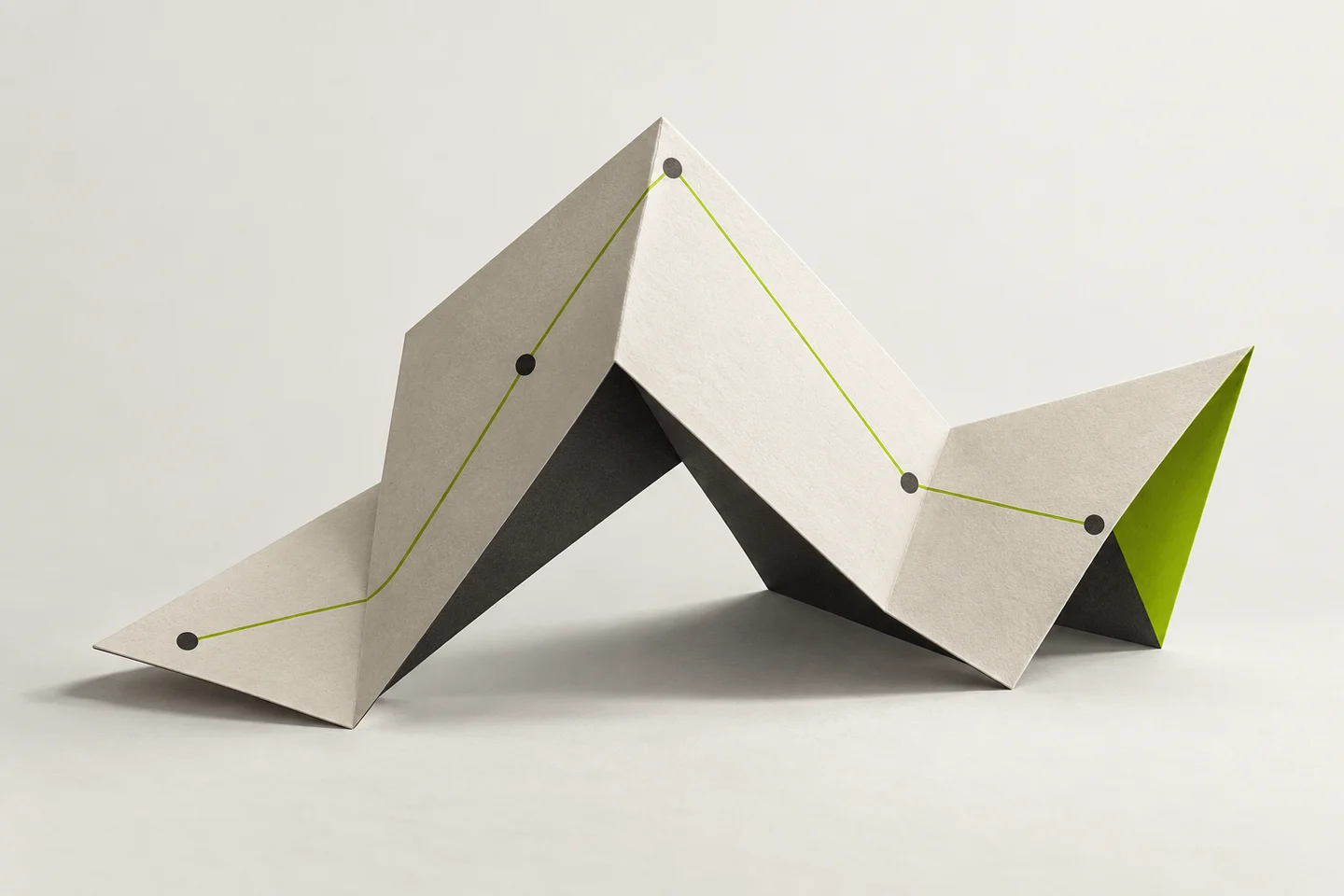 A lime path connects charcoal dots across an ivory origami sculpture